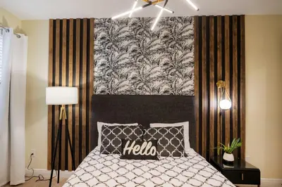 a bedroom with a bed with a black and white headboard at Stunning Luxury 9BR Encore Villa by Disney in Orlando