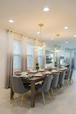 a dining room with a large wooden table and chairs at Stunning Luxury 9BR Encore Villa by Disney in Orlando