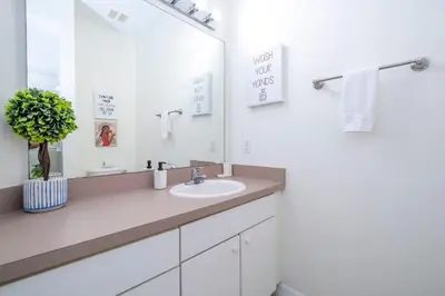 a bathroom with a sink and a mirror at Marvelous 3Bd w Jacuzzi at Terra Verde Resort 4757 in Kissimmee