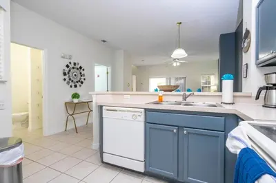 a kitchen with blue and white cabinets and a sink at Marvelous 3Bd w Jacuzzi at Terra Verde Resort 4757 in Kissimmee