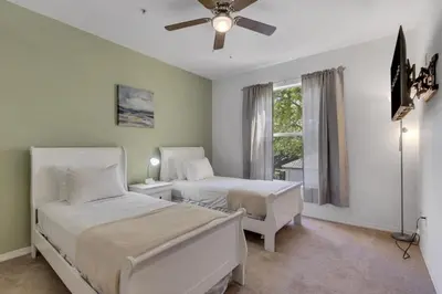 a bedroom with two beds and a ceiling fan at LC-8828-12-203DC - Legacy Dunes Condo for 6 guests in Kissimmee