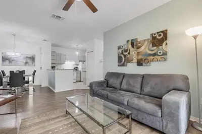 a living room with a leather couch and a table at LC-8828-12-203DC - Legacy Dunes Condo for 6 guests in Kissimmee