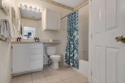 a bathroom with a toilet and a sink and a shower at LC-8828-12-203DC - Legacy Dunes Condo for 6 guests in Kissimmee