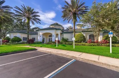 a house with palm trees in front of a street at LC-8828-12-203DC - Legacy Dunes Condo for 6 guests in Kissimmee