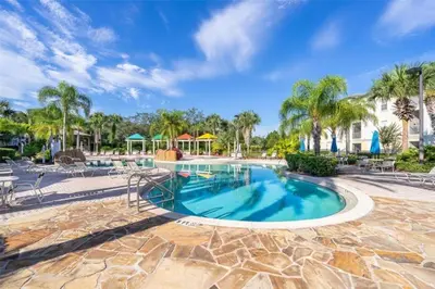 a swimming pool at a resort with palm trees at LD8830-12-308DC - Legacy Dunes condo for 8 guests in Kissimmee