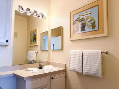 a bathroom with a sink and a mirror at LD8830-12-308DC - Legacy Dunes condo for 8 guests in Kissimmee