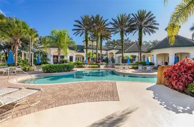 a villa with a swimming pool and palm trees at LD8830-12-308DC - Legacy Dunes condo for 8 guests in Kissimmee