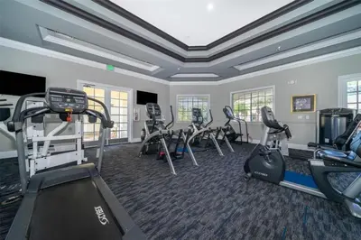 a gym with treadmills and ellipticals in a room at LD8830-12-308DC - Legacy Dunes condo for 8 guests in Kissimmee