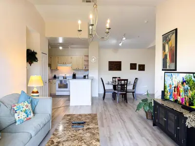 a living room with a couch and a kitchen at LD8830-12-308DC - Legacy Dunes condo for 8 guests in Kissimmee