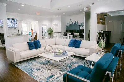 a living room with a white couch and blue chairs at LV2950-105LHC - 4 bedrooms - Lucaya Resort in Kissimmee