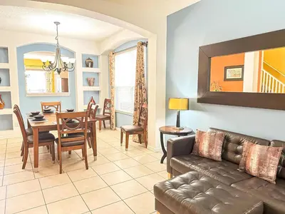 a living room with a couch and a table at EIR8505PH - Emerald's paradise by Disney in Kissimmee