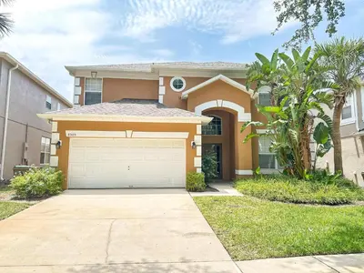 a house with a garage in front of it at EIR8505PH - Emerald's paradise by Disney in Kissimmee