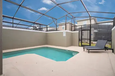 a swimming pool in the middle of a house at Brand New Cozy Retreat at Storey Lake Resort in Kissimmee