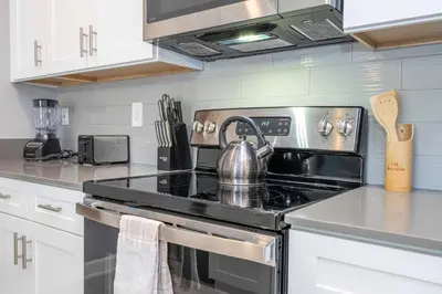 a kitchen with a stove with a tea kettle on it at Stunning 4 Bd w Pool @ Storey Lake Resort 2613 in Kissimmee