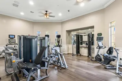 a gym with several treadmills and exercise machines at The Epic Edinburgh Top Floor Vista Cay Orlando in Orlando