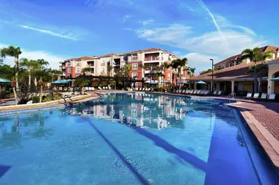 a large blue swimming pool with buildings in the background at The Epic Edinburgh Top Floor Vista Cay Orlando in Orlando