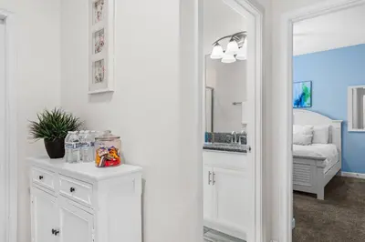 a bathroom with white cabinets and a mirror at Home with a pool at Storey Lake Resort in Kissimmee