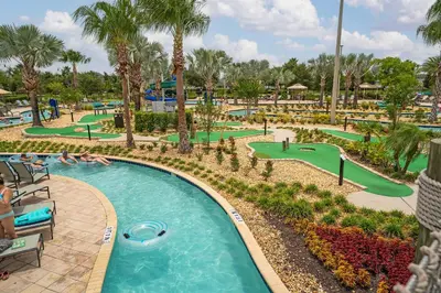 a pool at the resort with people playing golf at Home with a pool at Storey Lake Resort in Kissimmee