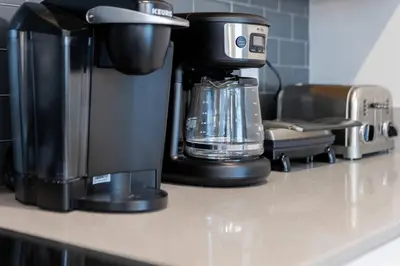 a coffee maker sitting on top of a counter at Family 4BR w Private Pool near Disney Parks in Kissimmee