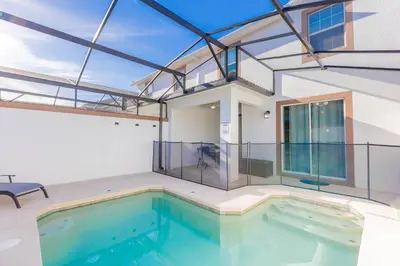 a house with a swimming pool with glass walls at Family 4BR w Private Pool near Disney Parks in Kissimmee
