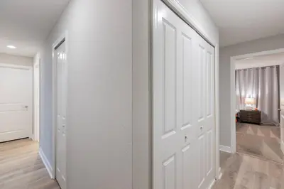 an empty hallway with white walls and a door at Family 4BR w Private Pool near Disney Parks in Kissimmee