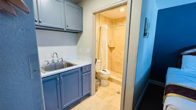a small bathroom with a sink and a toilet at Hotel Monte Carlo in Kissimmee