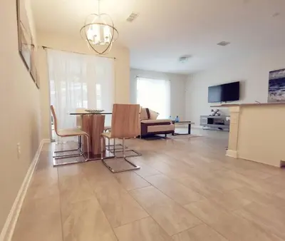 a large living room with a table and chairs at Makin Memories Gated Resort Style Community Storey Lake in Kissimmee