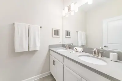 a bathroom with two sinks and a large mirror at Disney Dream Home Prime Location Private Pool in Kissimmee