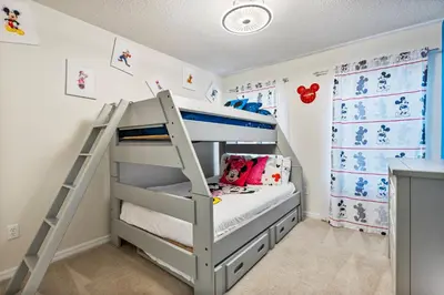 a bunk bed in a childs room with a ladder at Amazing 3Bdrms At Encantada- 6 miles from Disney in Kissimmee