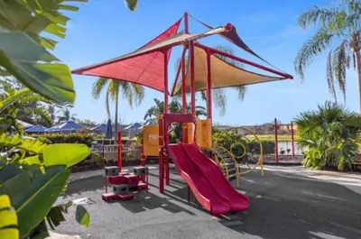 a playground with a red slide and a slideintend at Amazing 3Bdrms At Encantada- 6 miles from Disney in Kissimmee