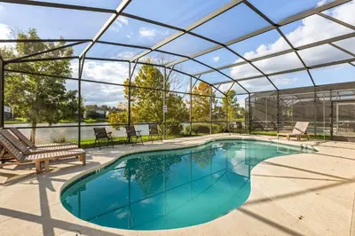a swimming pool with a glass roof at Sunny Stay in Orlando - 6BR Home with Pool! in Kissimmee