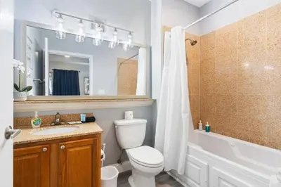 a bathroom with a toilet and a sink and a shower at Lakeview newly renovated condo near Disney in Orlando