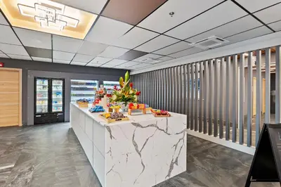 a lobby with a marble counter with food on it at Kompose Boutique Resort @ Theme Parks in Kissimmee
