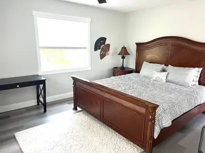 a bedroom with a wooden bed and a window at House close Baldwin-park Lake & Downtown Orlando in Orlando