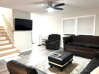 a living room with a couch and a ceiling fan at House close Baldwin-park Lake & Downtown Orlando in Orlando