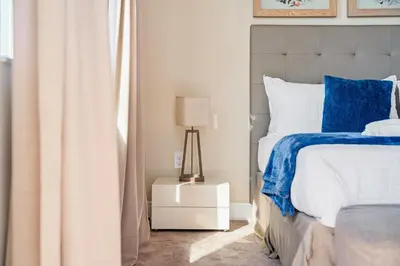 a bedroom with a bed with a blue blanket at 4 BR Home w/ Resort Amenities + 3 Mi to Disney in Orlando