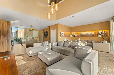 a living room with a couch and a table at Outdoor Kitchen + 8 Min to Disney + Resort Cabanas in Orlando