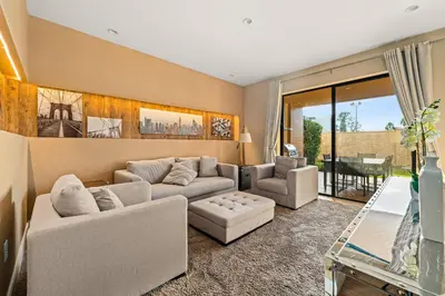 a living room with two couches and a table at Outdoor Kitchen + 8 Min to Disney + Resort Cabanas in Orlando
