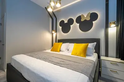 a bedroom with a large bed with yellow pillows at 6163 Fantastic Home with 12BD in Orlando