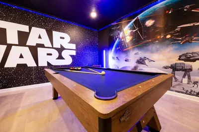 a billiard table in a room with a star wars wall at Incredible 6BR Villa by Disney Private Pool Games in Kissimmee