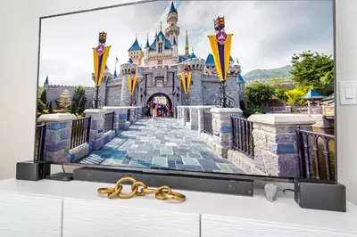 a tv on a dresser with a castle at New Exclusive Villa 5 min to Disney in Orlando