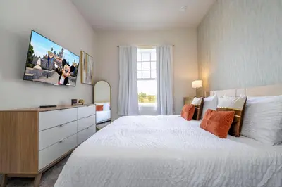 a bedroom with a large white bed and a window at New Exclusive Villa 5 min to Disney in Orlando
