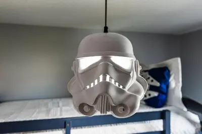 a mask hanging over a bed in a room at Amazing 4BdrmsPrivate Hot Tub7 miles from Disney in Kissimmee
