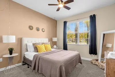 a bedroom with a bed and a ceiling fan at Perfect Disney Holiday! Private Pool, Spa, Resort! in Kissimmee
