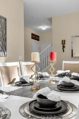 a dining room with a table with plates and lamps at Perfect Disney Holiday! Private Pool, Spa, Resort! in Kissimmee