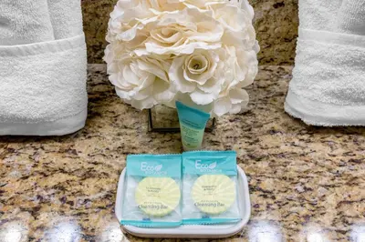 a flower in a vase on a counter next to towels at Perfect Disney Holiday! Private Pool, Spa, Resort! in Kissimmee