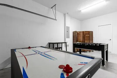 a ping pong table in a room with a ping pong ball at Perfect Disney Holiday! Private Pool, Spa, Resort! in Kissimmee