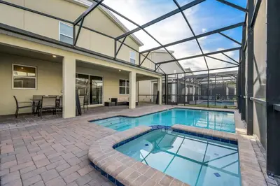 an indoor swimming pool with a glass ceiling at Charming Home Ideal Location Spacious Game Room in Kissimmee