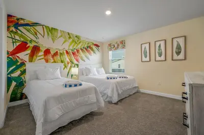 a bedroom with two beds and a mural on the wall at Charming Home Ideal Location Spacious Game Room in Kissimmee