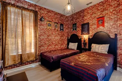 a bedroom with two beds and a brick wall at Hibiscus Villa in Orlando